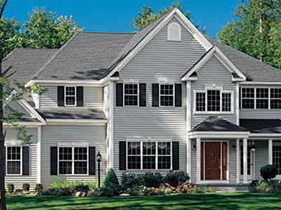 Front view of a two-story, mid-class home with white Alside siding
