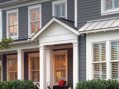 Front view and close up of a two-story, mid-class home with dark gray James Hardie siding