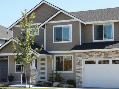 Front view and close up of a two-story, mid-class home with dark gray James Hardie siding