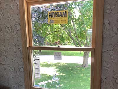Wood-framed Marvin window newly installed in a home by Rebel Exteriors Inc.