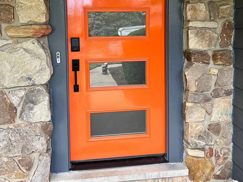 Close up of a newly installed orange front door